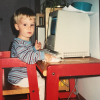 pixelated pic of a much younger me, wearing a striped shirt, sitting in front of an 11yr old, broken, mac se/30